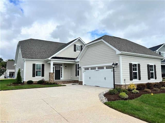 craftsman-style home featuring a garage, a porch, and a front yard