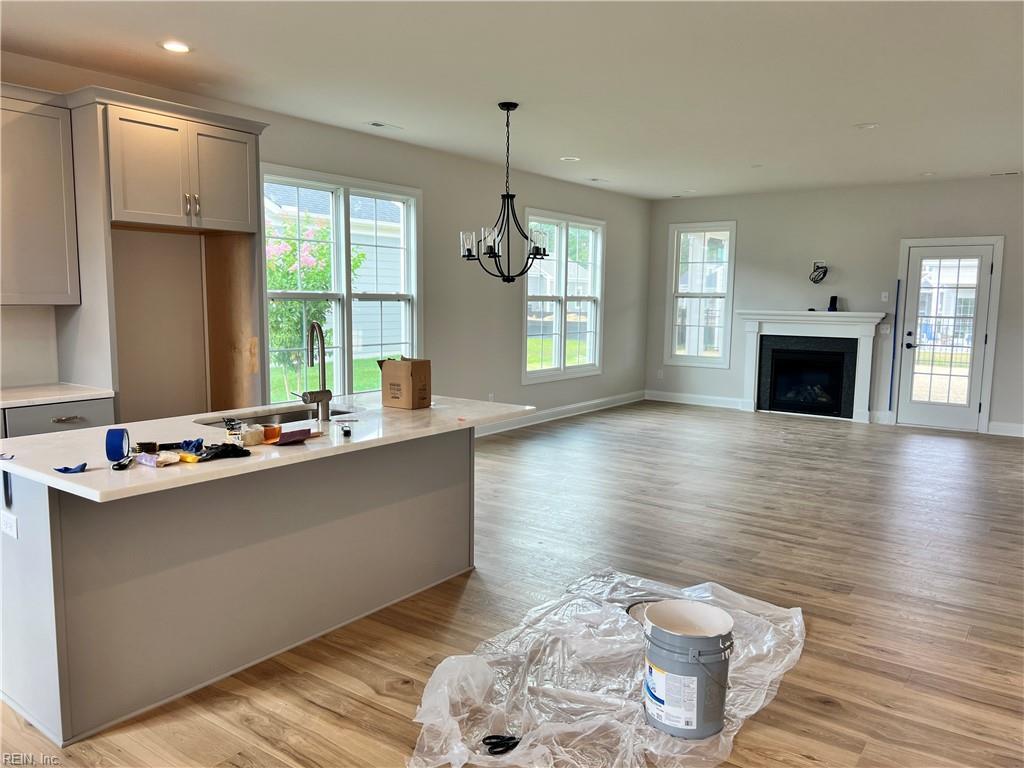 kitchen featuring a sink, gray cabinets, light countertops, a chandelier, and recessed lighting