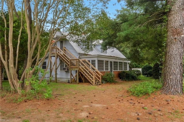 rear view of house with a sunroom and cooling unit