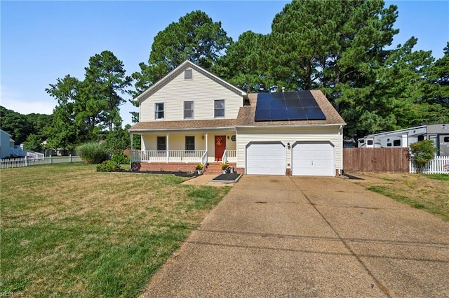 view of front of home with driveway, a front yard, covered porch, fence, and a garage