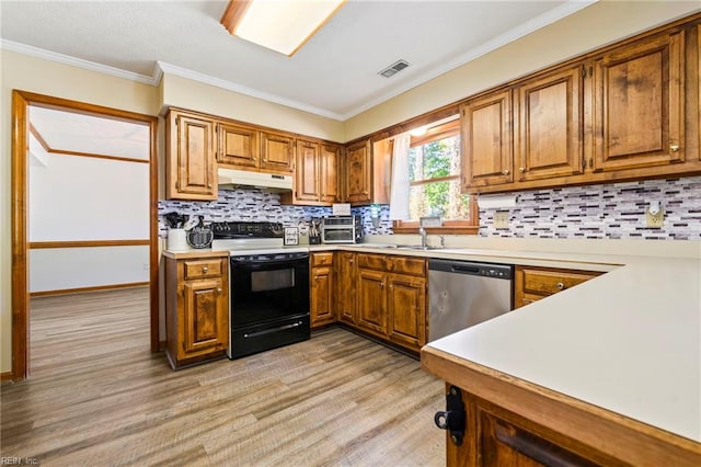 kitchen with black range with electric stovetop, stainless steel dishwasher, light wood-style flooring, under cabinet range hood, and visible vents