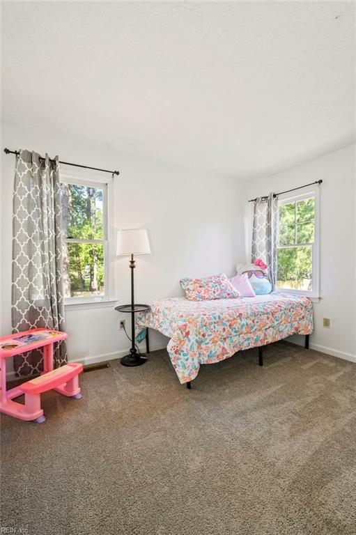 bedroom featuring baseboards and carpet flooring