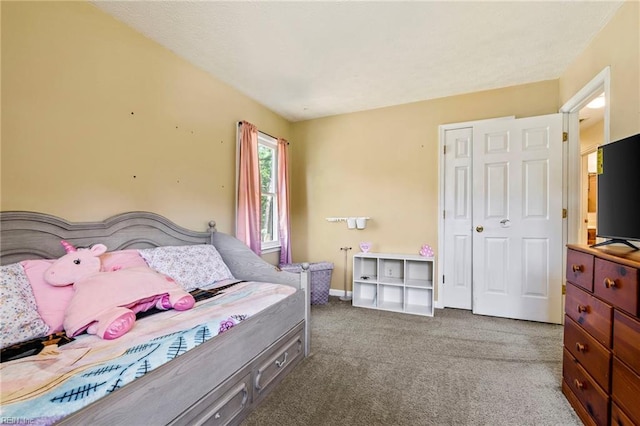 bedroom featuring baseboards, a closet, and carpet