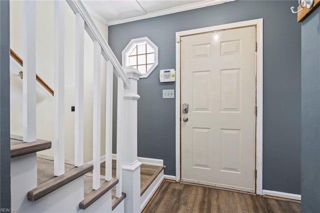 foyer featuring baseboards, dark wood-style flooring, stairway, and crown molding