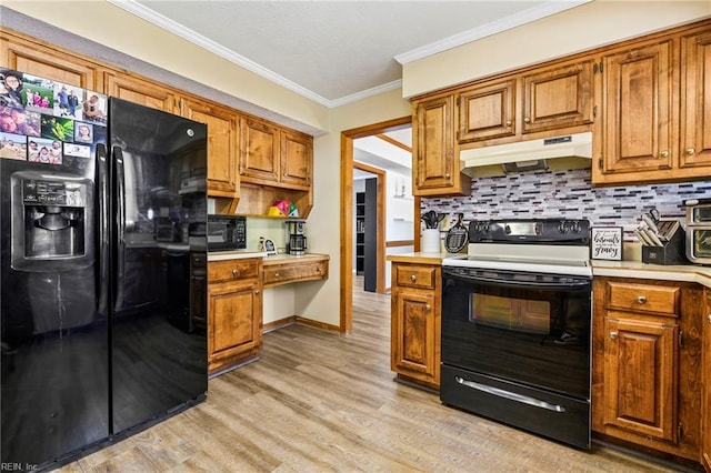 kitchen featuring light countertops, under cabinet range hood, light wood-style floors, black appliances, and brown cabinetry