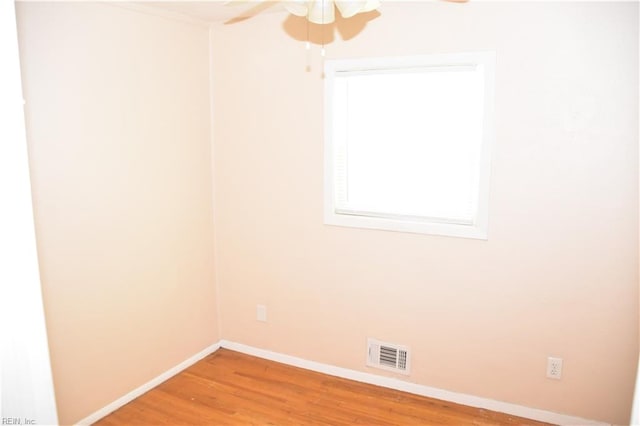 spare room with ceiling fan and hardwood / wood-style flooring