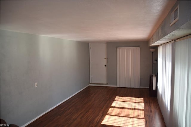 empty room featuring dark wood-type flooring