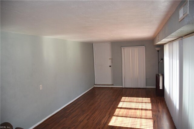 empty room featuring dark hardwood / wood-style flooring