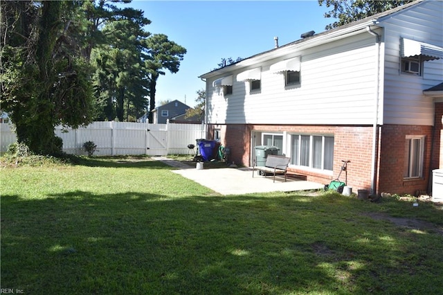 back of property featuring a yard and a patio