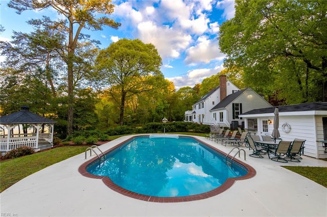 view of swimming pool with a patio area and a gazebo