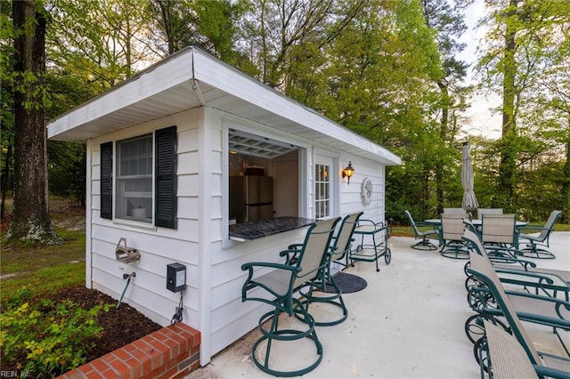 view of patio / terrace featuring an outbuilding