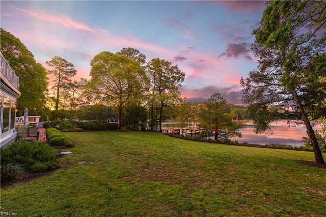 yard at dusk with a water view