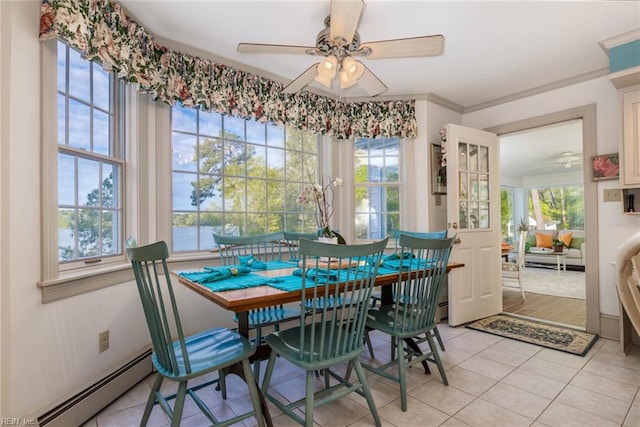 tiled dining room featuring baseboard heating, crown molding, and ceiling fan