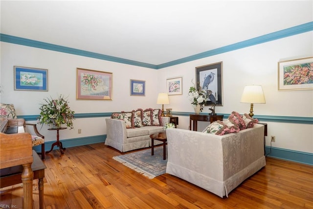 living room featuring ornamental molding and light wood-type flooring