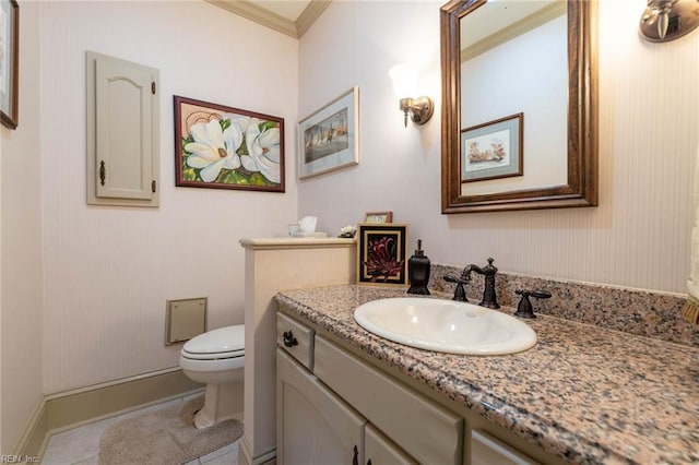 bathroom featuring toilet, ornamental molding, and vanity