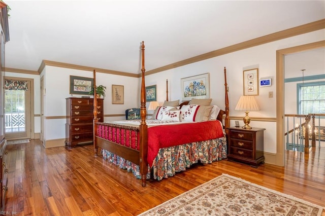 bedroom featuring crown molding and wood-type flooring