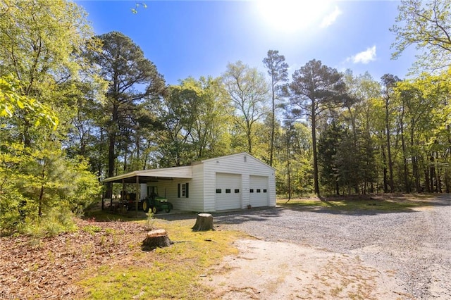 view of property exterior with an outdoor structure and a garage