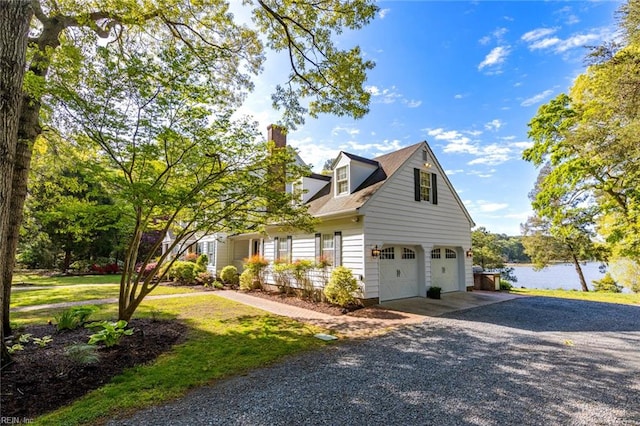 view of front of property with a garage and a front lawn