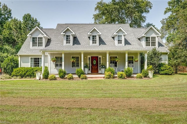 new england style home featuring a front lawn and a porch