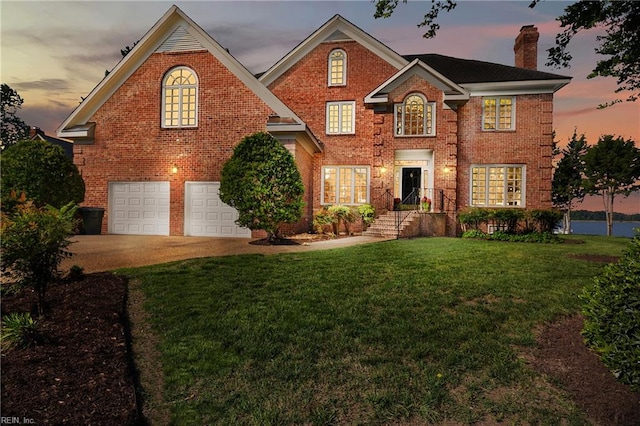 view of front property with a yard and a garage