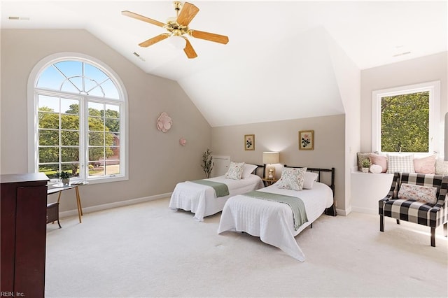 bedroom with light carpet, multiple windows, lofted ceiling, and ceiling fan