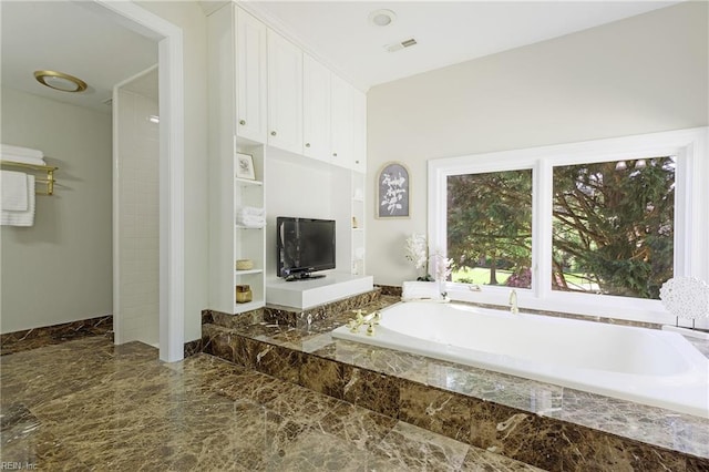 bathroom featuring tiled bath