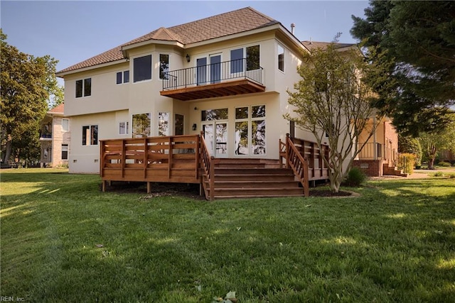 rear view of property with a yard and a balcony