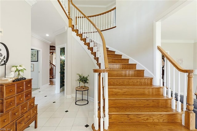 stairway featuring crown molding and tile patterned flooring