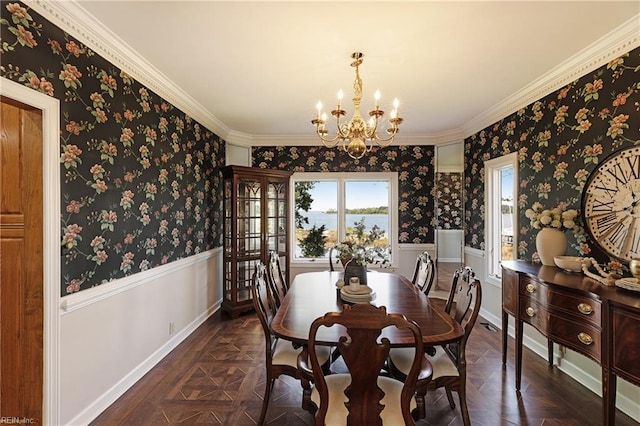 dining area featuring crown molding, a notable chandelier, and dark parquet flooring