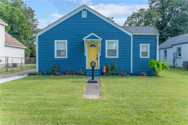 bungalow with a front yard and central AC unit