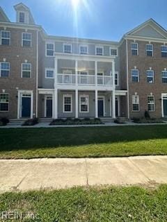 exterior space with a balcony and a front lawn