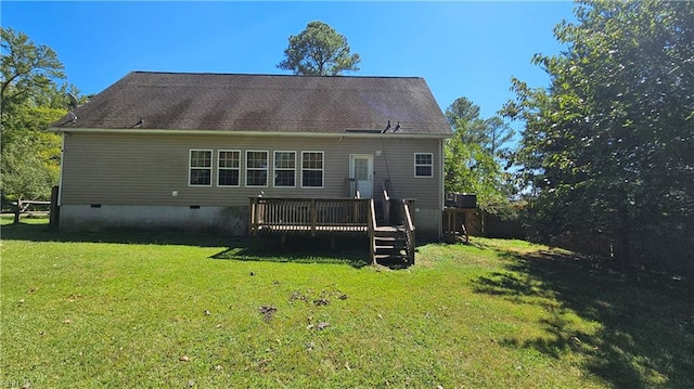 rear view of house with a lawn, a wooden deck, and central AC