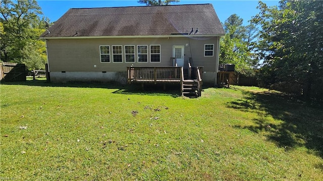 back of property featuring a yard and a deck