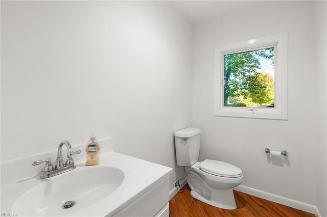 bathroom with vanity, toilet, and wood-type flooring