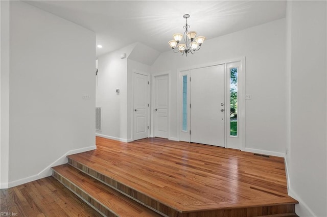 foyer featuring an inviting chandelier and hardwood / wood-style floors