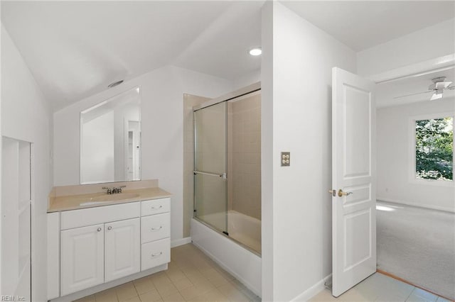 bathroom featuring tile patterned floors, vaulted ceiling, combined bath / shower with glass door, ceiling fan, and vanity