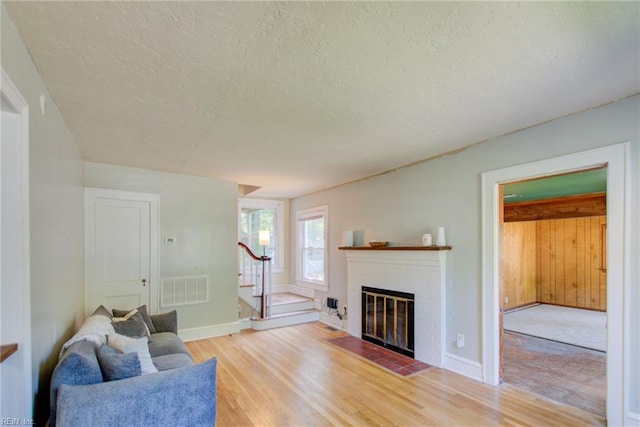 living room with a textured ceiling and hardwood / wood-style floors