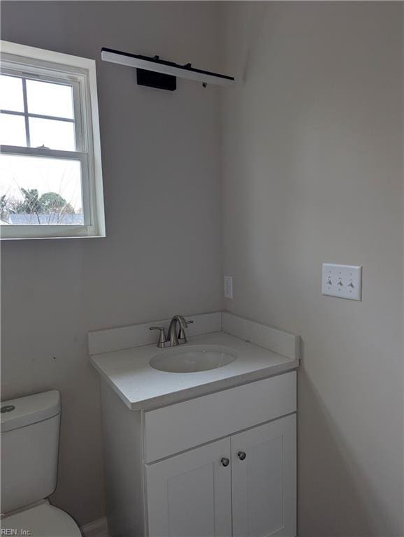 bathroom with vanity and toilet