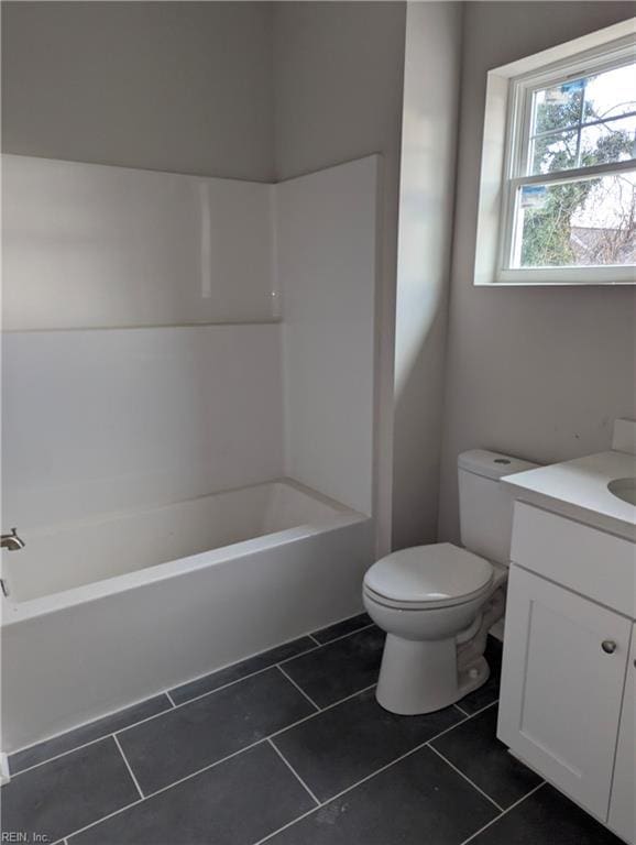 full bathroom featuring bathing tub / shower combination, tile patterned flooring, vanity, and toilet