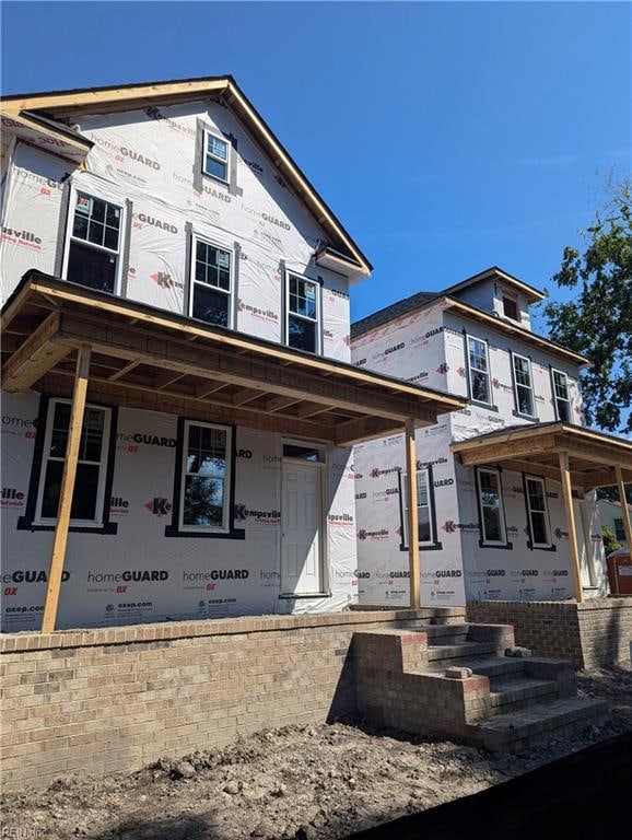 unfinished property with covered porch