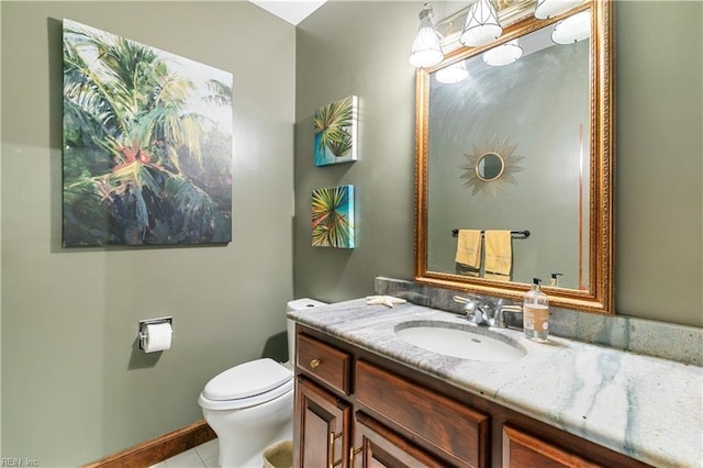 half bath featuring tile patterned floors, toilet, and vanity