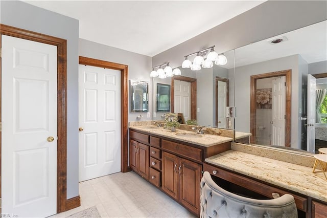 full bathroom with double vanity and a sink