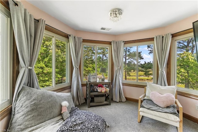 living area featuring visible vents, plenty of natural light, and baseboards