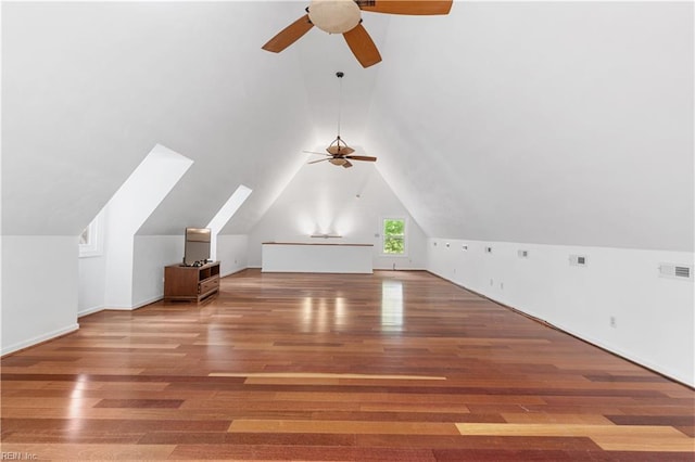 bonus room with vaulted ceiling, ceiling fan, visible vents, and wood finished floors