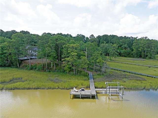 dock area featuring a forest view and a water view