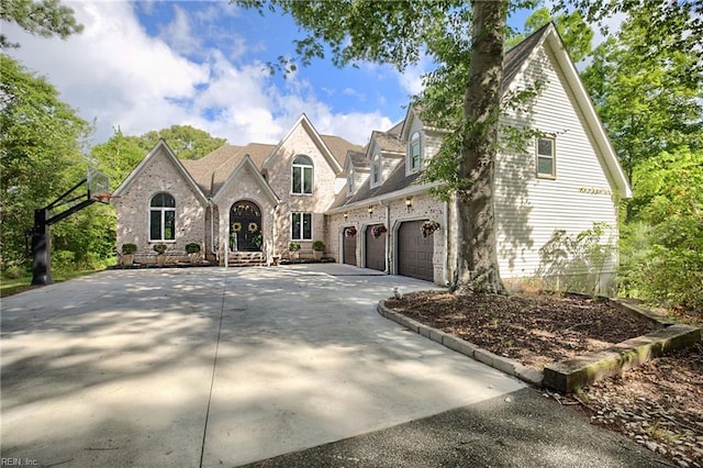 view of front of home featuring brick siding, concrete driveway, and a garage