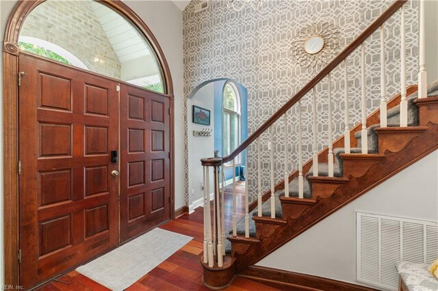 stairway with ornamental molding and hardwood / wood-style flooring