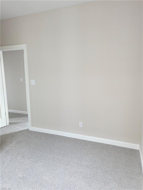 unfurnished room with baseboards and carpet flooring