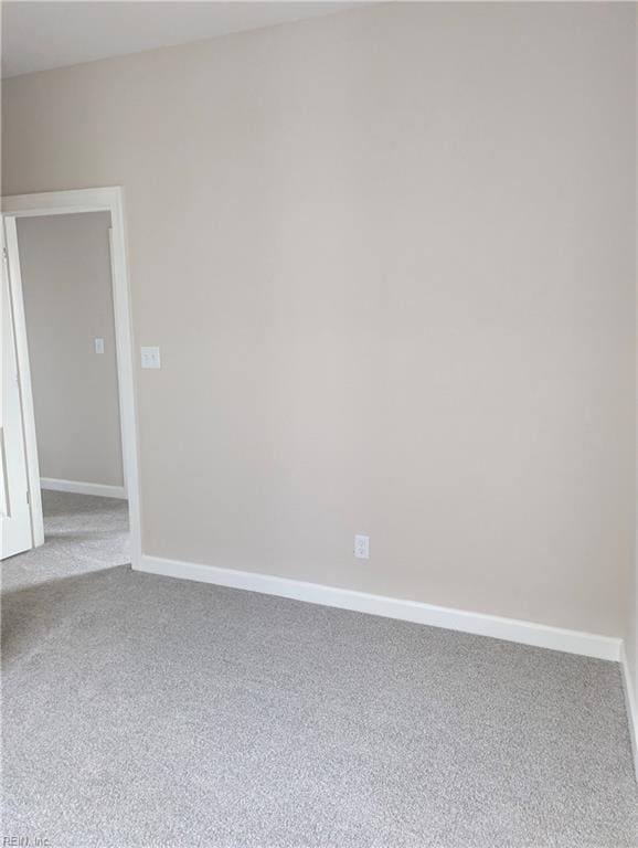 carpeted spare room with baseboards