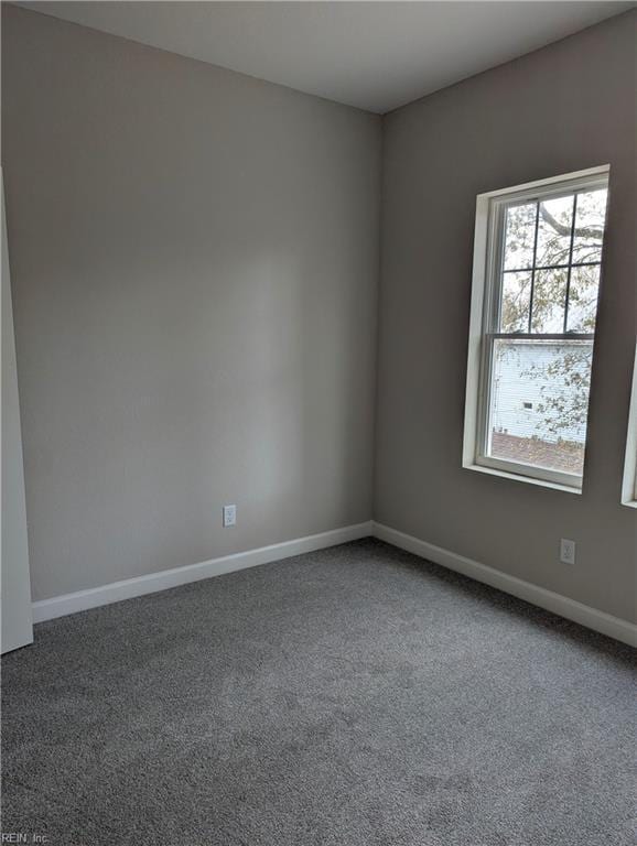 carpeted spare room with baseboards